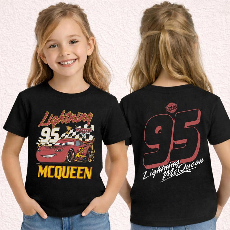 May include: Black t-shirt featuring Lightning McQueen from the Cars movie. The front displays the text "Lightning 95 McQueen" with a red race car and checkered flags. The back of the shirt shows the number "95" and "Lightning McQueen".