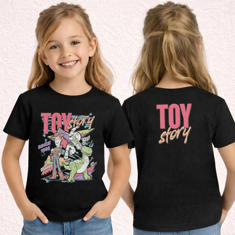 May include: Black t-shirt featuring a colorful graphic of Toy Story characters, including Woody, Buzz Lightyear, and Rex. The front of the shirt displays the words "TOY STORY" and "SINCE 1995". The back of the shirt has the words "TOY STORY".
