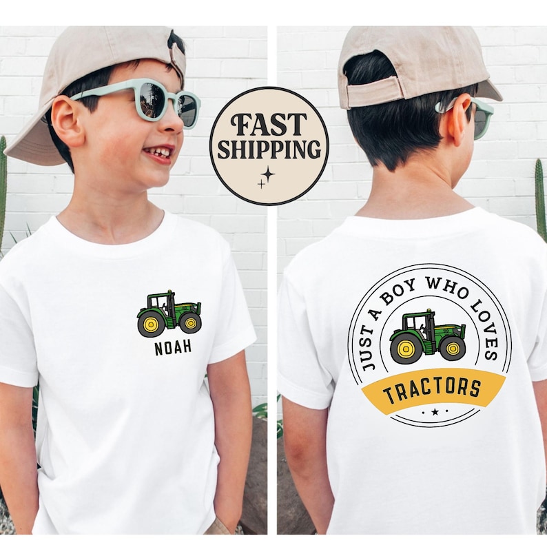 May include: White t-shirt with a green and yellow tractor graphic. The front of the shirt has the name "Noah" below the tractor. The back of the shirt says "Just a boy who loves tractors" in a circular design.
