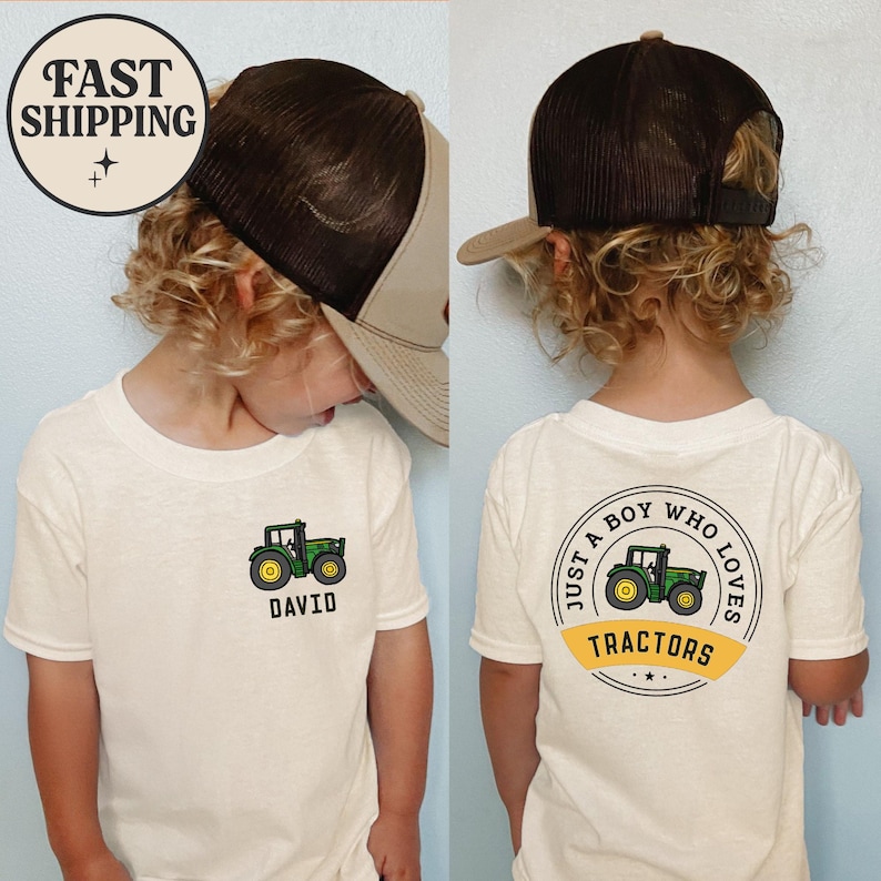 May include: A child wearing a cream-colored t-shirt and a brown trucker hat. The shirt features a green tractor graphic with the name "DAVID" below it. The back of the shirt has a circular design that reads "JUST A BOY WHO LOVES TRACTORS."