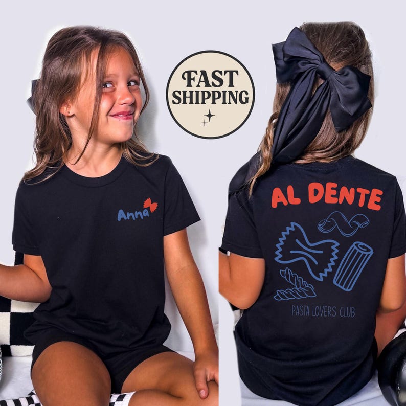 May include: Black t-shirt with the name "Anna" in blue and a red heart design. The back of the shirt features the words "AL DENTE" in red, pasta illustrations, and "PASTA LOVERS CLUB" in blue. The image also includes a "FAST SHIPPING" graphic.