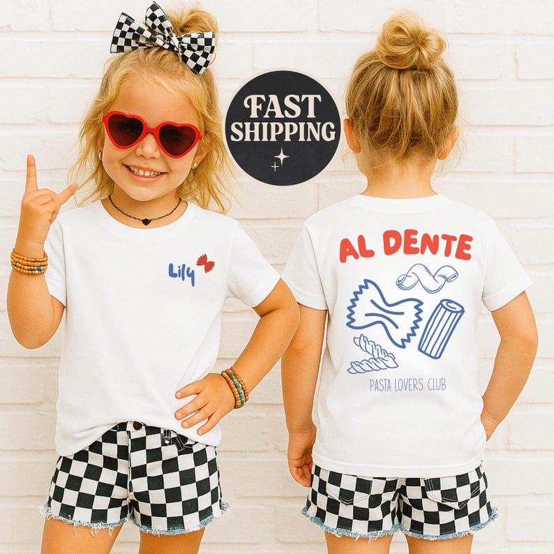 May include: A young girl wearing a white t-shirt with the name "Lily" and a red bow graphic. She is also wearing heart-shaped sunglasses, a black and white checkered bow, and matching shorts. The back of the shirt says "AL DENTE" with pasta graphics.