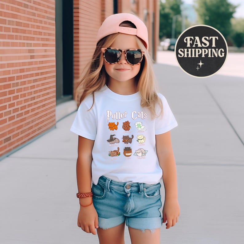 May include: A young person wearing a white t-shirt with the text "Potter Cats" and cartoon cat illustrations. The person is also wearing a pink baseball cap, sunglasses, and denim shorts. A round black and white "Fast Shipping" graphic is in the background.