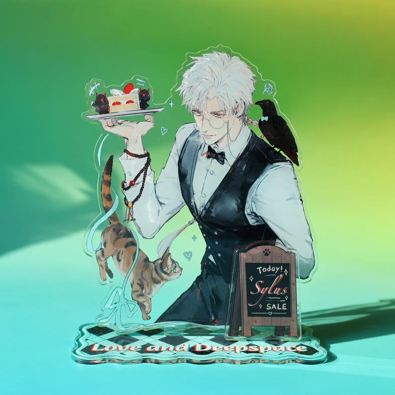 May include: Acrylic stand featuring an anime-style character in a waiter's uniform, holding a cake. A crow perches on his shoulder, and two cats are depicted. A small sign reads "Today! Sylas SALE". The base reads "Love and Deepspace".