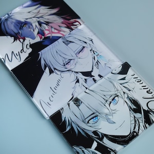 May include: Stacked glass coasters featuring anime-style character illustrations. Each coaster displays a different character with detailed facial features, including blue and purple eyes, and white hair. The coasters have black and white backgrounds with handwritten text.