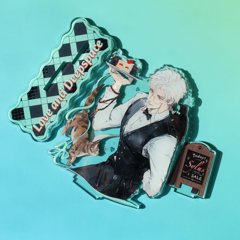 May include: Acrylic stand featuring an anime-style character with white hair, wearing a vest and holding a cake. A cat is present. The stand has the text "Love and Deepspace" and a small sign that says "Today! Sylas SALE".
