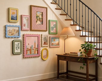 May include: A gallery wall featuring ten assorted rectangular and oval picture frames with wavy edges in various colors, including pink, blue, green, and yellow, surrounding a wooden console table with a pleated lamp and a potted plant.