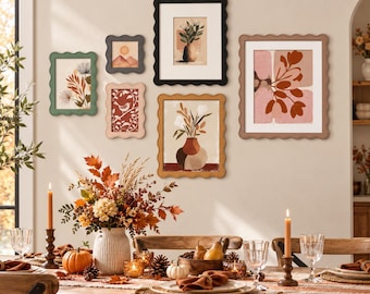 May include: A gallery wall arrangement featuring six scalloped-edge picture frames in black, tan, green, and pink, surrounding various botanical and landscape art prints. The frames are displayed on a wall above a dining table set for autumn.