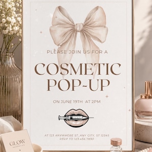 May include: A rectangular sign in a gold frame featuring a large beige bow illustration, the text PLEASE JOIN US FOR A COSMETIC POP-UP ON JUNE 19TH AT 2PM, an illustration of lips with a syringe, and address and RSVP contact information.