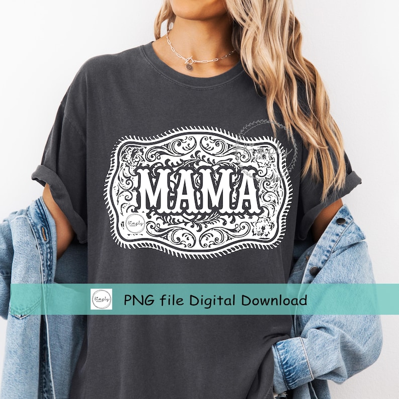 May include: Dark gray t-shirt with a white decorative design featuring the word "MAMA" in bold letters. The design is framed by an ornate, scroll-like border. The shirt is part of a digital download.