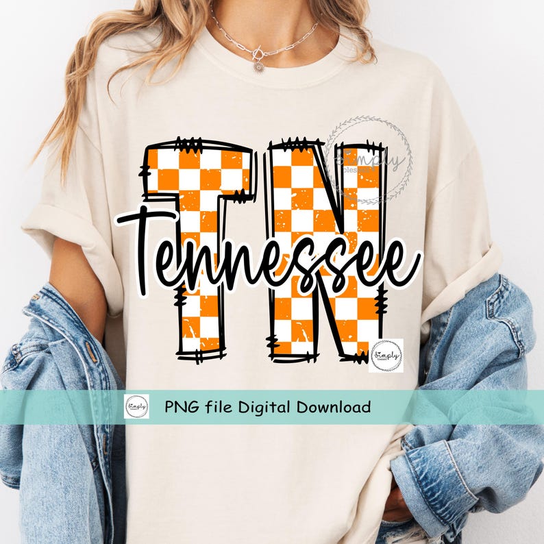 May include: Cream-colored t-shirt featuring the word "Tennessee" in a black script font, with "TN" in large orange and white checkered letters. The shirt includes the text "PNG file Digital Download".