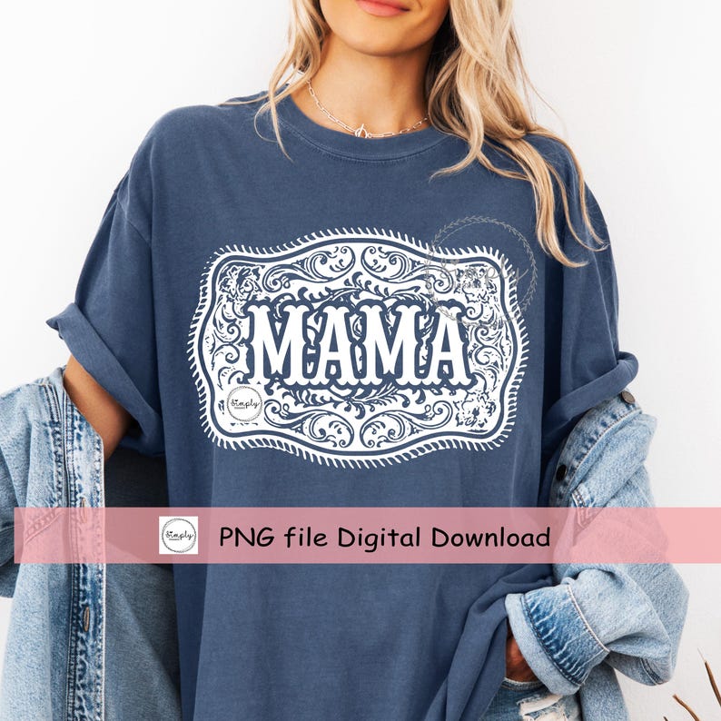 May include: A navy blue t-shirt with rolled-up sleeves. The shirt features a white decorative design with the word "MAMA" in the center. The design is framed by an ornate border. The shirt is part of a digital download.
