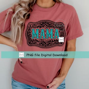 May include: A pink t-shirt with a black and white design of a belt buckle with the word "MAMA" in turquoise lettering.