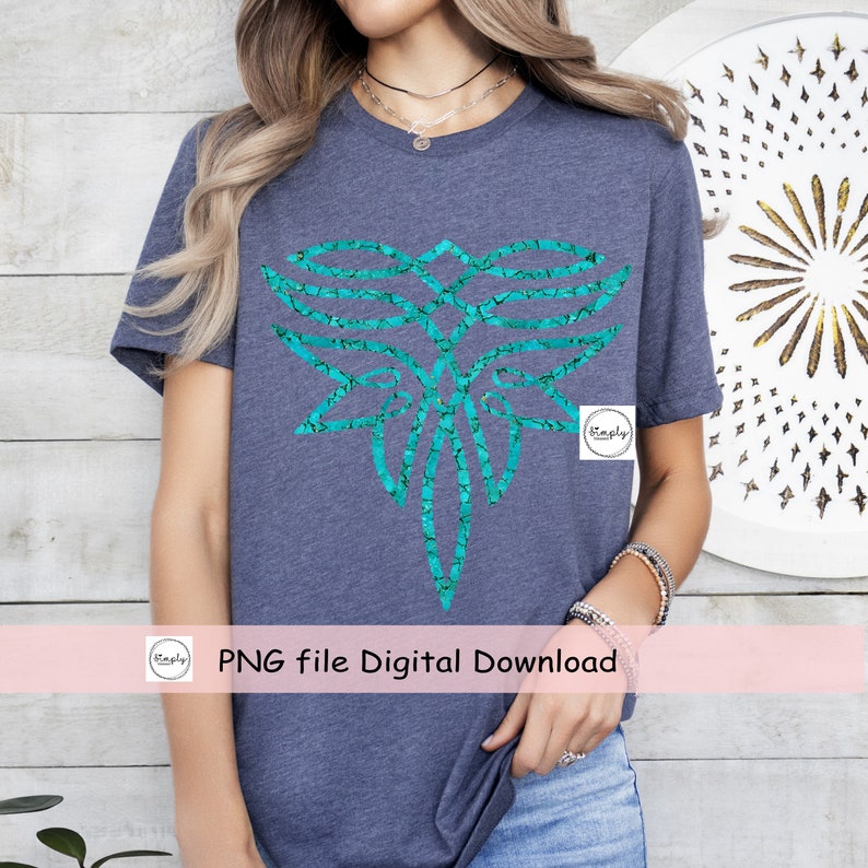 May include: A teal blue graphic design of a stylized geometric shape with a cracked texture on a dark blue t-shirt. The text "PNG file Digital Download" is on a pink banner below the shirt.