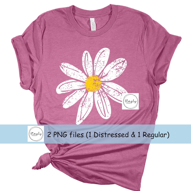 May include: A pink t-shirt with a distressed white daisy graphic. The daisy has a yellow center. The text "Simply" is in a circle on the shirt.