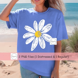 May include: A blue t-shirt with a white distressed daisy graphic. The daisy has a yellow center. The text "2 PNG files (1 Distressed & 1 Regular)" is on a pink banner below the image.