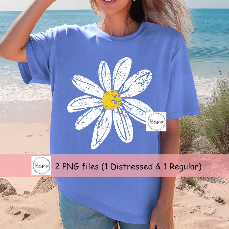 May include: A blue t-shirt with a white distressed daisy graphic. The daisy has a yellow center. The text "2 PNG files (1 Distressed & 1 Regular)" is on a pink banner below the image.