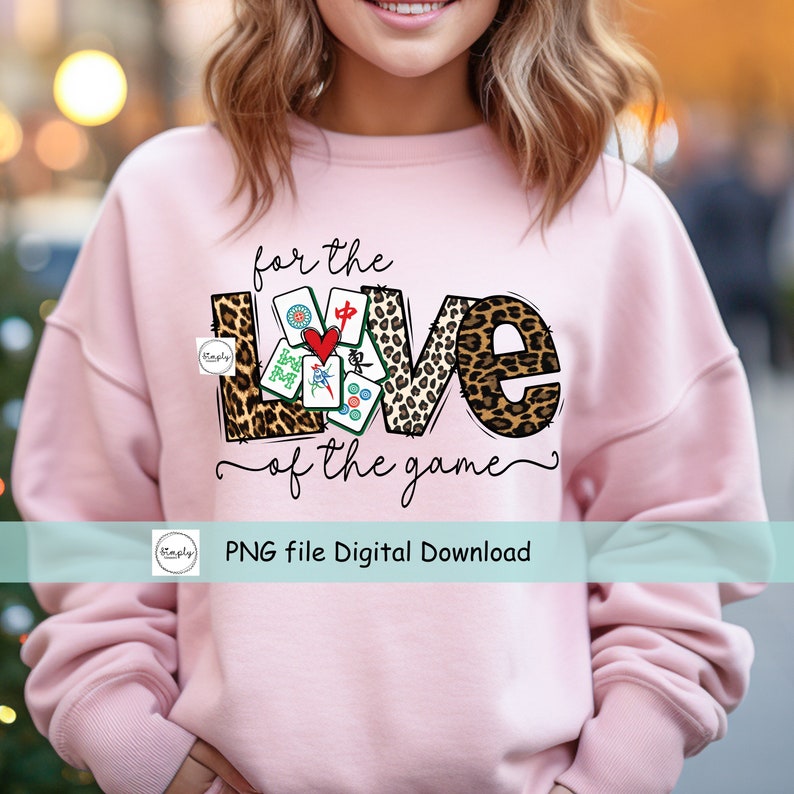 May include: A pink sweatshirt with the text "for the love of the game" and a graphic of the word "love" made of mahjong tiles and leopard print.