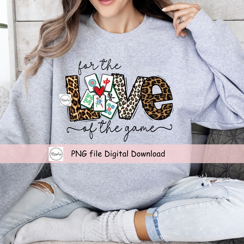 May include: A gray sweatshirt with the words "for the love of the game" and a graphic of the word "love" made of mahjong tiles and leopard print. The graphic is surrounded by a black outline.