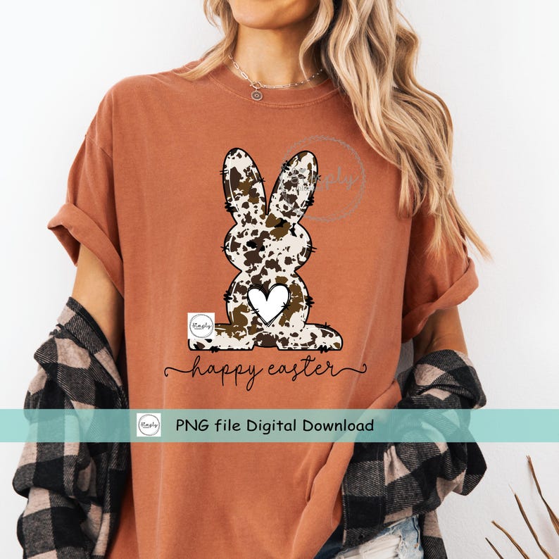 May include: A brown t-shirt with a white and brown cow print Easter bunny graphic and the text "happy easter". The text "PNG file Digital Download" is also included.