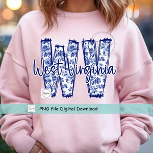 May include: A pale pink sweatshirt with a blue floral "WV" design and the words "West Virginia" in script. The design is centered on the chest. A banner below reads "PNG file Digital Download".