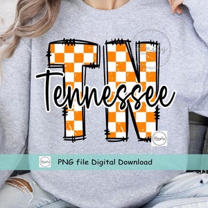 May include: A gray sweatshirt featuring the word "Tennessee" in a cursive font, with the letters "TN" in a checkered orange and white pattern. The sweatshirt also includes the text "PNG file Digital Download".