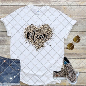 May include: White t-shirt with a leopard print heart and the word "Mimi" in black script.