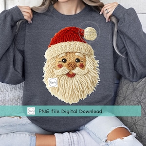 May include: A dark gray sweatshirt featuring a knitted Santa Claus face with a red hat and a fluffy white beard. The image includes the text "PNG file Digital Download".