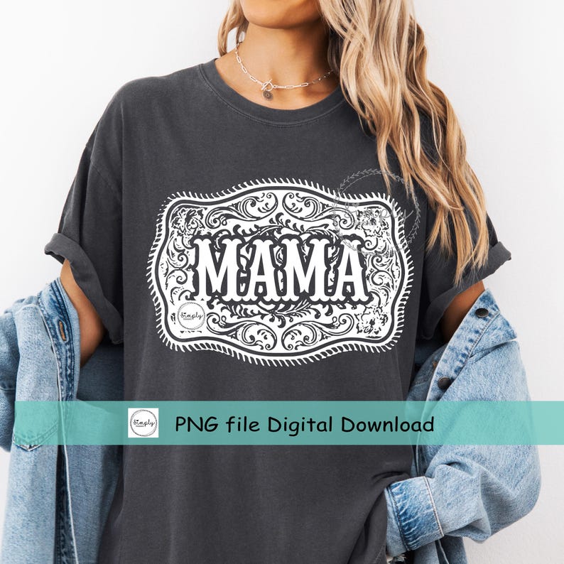 May include: Dark gray t-shirt with a white decorative design featuring the word "MAMA" in bold letters. The design is framed by an ornate, scroll-like border. The shirt is part of a digital download.
