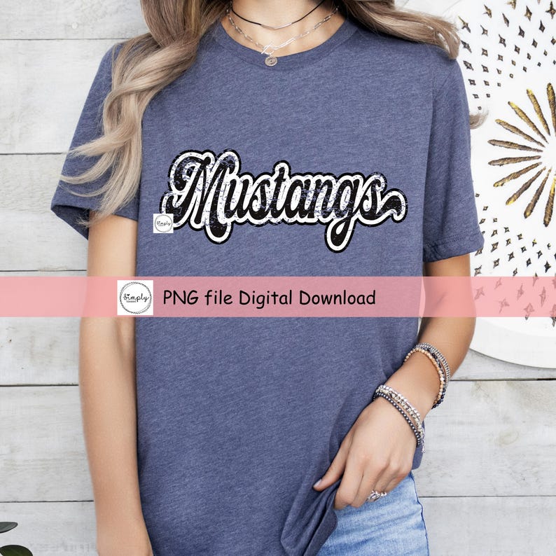 May include: A blue t-shirt with a white and black graphic that says "Mustangs" in a distressed font.