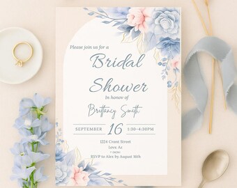 May include: A bridal shower invitation with floral accents in shades of blue and pink. The invitation includes the text "Bridal Shower" and details for the event, including the date, time, and location. Decorative elements include flowers, a ring, and a ribbon.