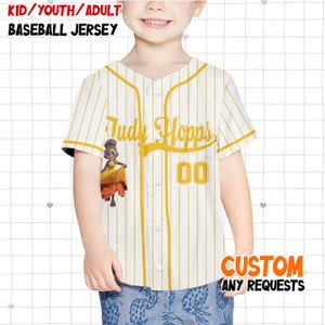 May include: White baseball jersey with yellow pinstripes, featuring the name "Judy Hopps" and the number "00" in yellow. The jersey includes an image of Judy Hopps. Text at the top reads "KID/YOUTH/ADULT BASEBALL JERSEY". The bottom right corner says "CUSTOM ANY REQUESTS".