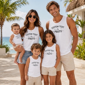 May include: A family of five wearing matching white tank tops, each featuring the black printed text CUSTOM TEXT or PHOTO. The group consists of two adults and three children, all dressed in casual summer attire including denim and beige shorts.