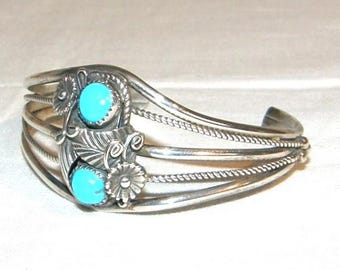 Beautiful vintage bangle made of 925 sterling silver with two imitation turquoise stones, very richly decorated with flowers and tendrils.