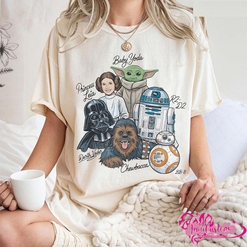 May include: A white ceramic mug with a black handle and the text "But First, Coffee" in a bold, black font. The mug is set against a blurred background, suggesting a cozy setting.