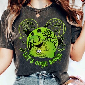 May include: Dark grey t-shirt with a neon green graphic of Oogie Boogie from The Nightmare Before Christmas. The design includes bats, ghosts, and the text "Let's Oogie Boogie". The shirt has a vintage, worn appearance.
