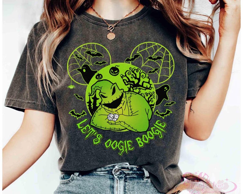 May include: Dark grey t-shirt with a neon green graphic of Oogie Boogie from The Nightmare Before Christmas. The design includes bats, ghosts, and the text "Let's Oogie Boogie". The shirt has a vintage, worn appearance.