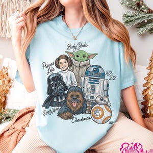 May include: A white ceramic mug with a black handle and the text "But First, Coffee" in a black, handwritten-style font. The mug is on a white surface.