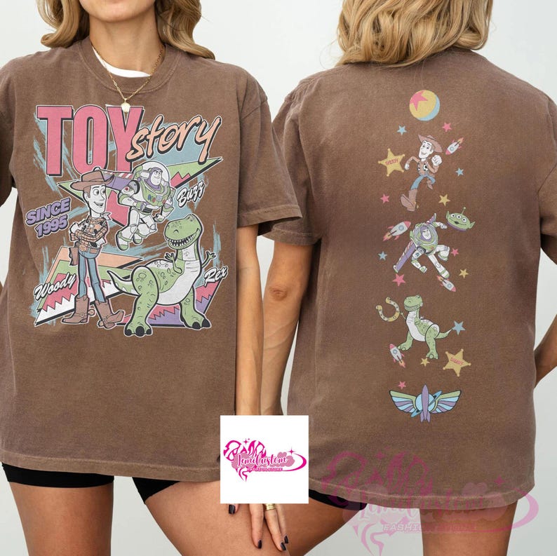 May include: Brown t-shirt featuring the text "Toy Story" with Woody, Buzz Lightyear, and Rex graphics. The back of the shirt displays additional character graphics. The shirt has a vintage, faded look.