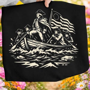 May include: Black tote bag featuring a historical illustration of a boat with figures, including one standing with a flag. The flag has stars and stripes. The boat is in choppy water, with the figures rowing.