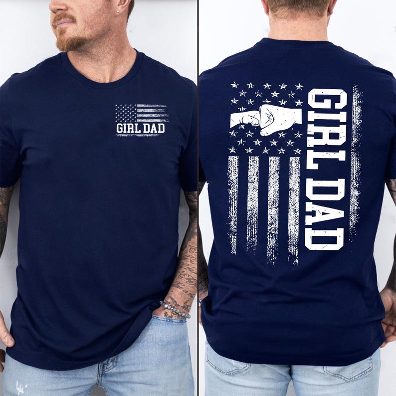 K&ouml;nnte beinhalten: Marineblaues T-Shirt mit einem verblassten amerikanischen Flaggen-Design. Auf der Vorderseite steht der Text "GIRL DAD" unter der Flagge. Auf der R&uuml;ckseite ist eine Faust-Grafik in einem Flaggen-Design abgebildet, mit vertikal gedrucktem "GIRL DAD".