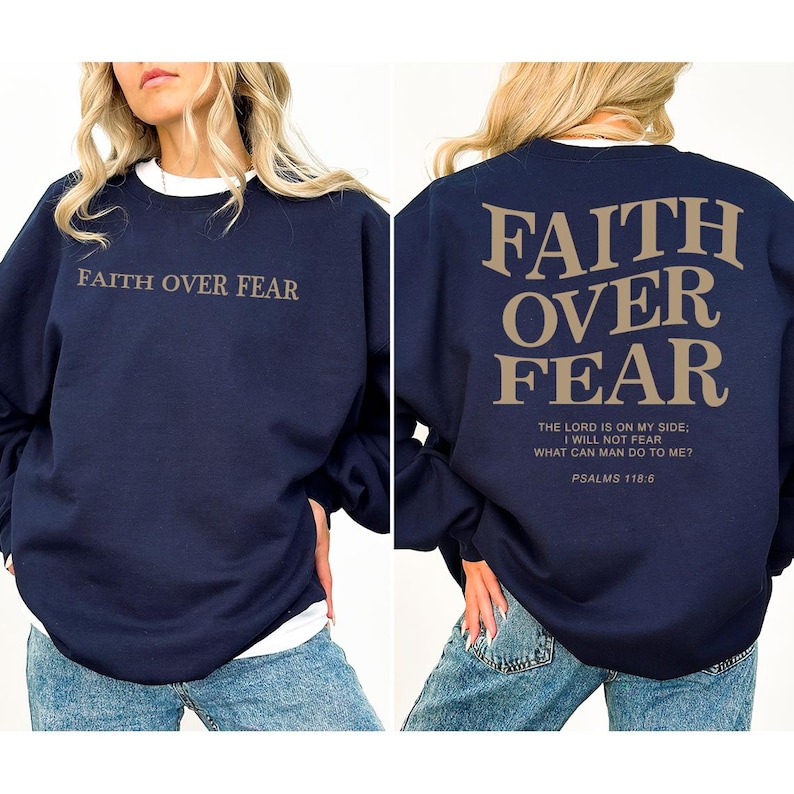 May include: Navy blue sweatshirt with the text "FAITH OVER FEAR" printed on the front and back. The back of the sweatshirt also includes the text "THE LORD IS ON MY SIDE: I WILL NOT FEAR WHAT CAN MAN DO TO ME? PSALMS 118:6".