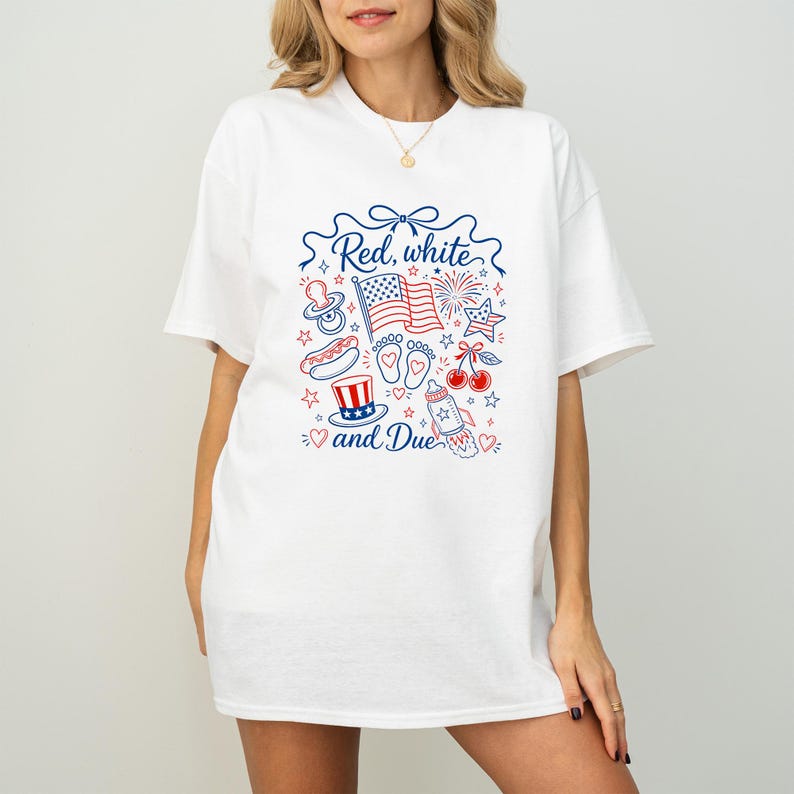 May include: White t-shirt with a patriotic graphic in red and blue. The design includes an American flag, fireworks, and the text "Red, white and Due". Other illustrations include a baby bottle, pacifier, and cherries.