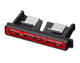 May include: A black and red Quattro emblem with silver metal clips. The Quattro logo is in red, with a black border. The emblem is designed to be mounted on a vehicle.