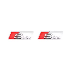 May include: Two S line car emblems. Each emblem features a silver "S" and "line" text on a white background, with a red accent. The emblems are rectangular and have a glossy finish.