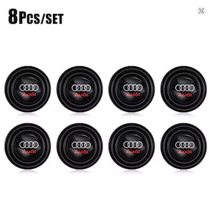 May include: A set of 8 circular black car door shock absorber pads, each featuring the white Audi logo and the red Audi brand name in the center. The text 8Pcs/SET is displayed in the upper left corner of the image above the eight identical items.
