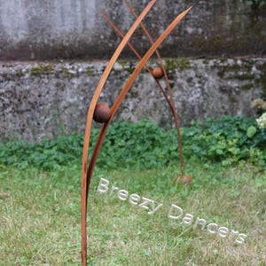 A Heron looking at the sky: garden rusty metal sculpture. Weathered steel big garden birds