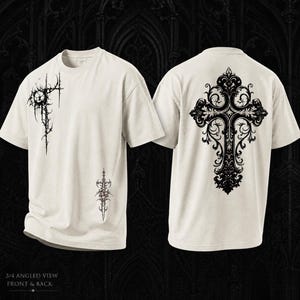 May include: Off-white t-shirt with black gothic cross designs. The front features a spiky, circular design and a vertical, ornate pattern. The back displays a large, detailed cross. The shirt is viewed from a 3/4 angle, front and back.