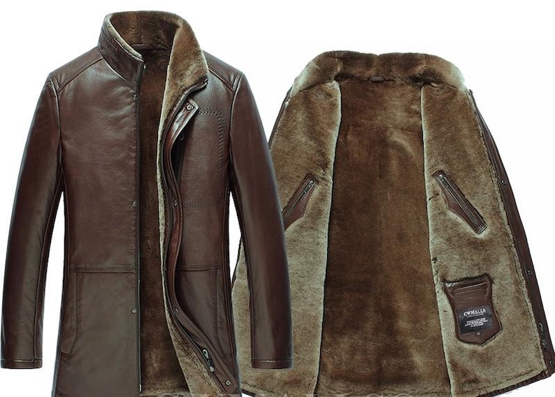 May include: A brown leather coat with a fur lining. The coat has a high collar, button closure, and multiple pockets. The interior is a lighter shade of brown, providing warmth and style. The coat is designed for cold weather.