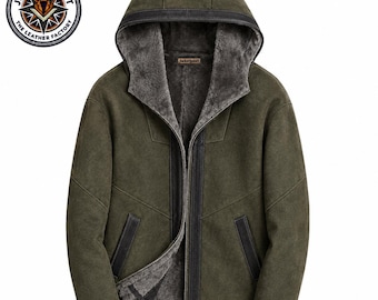 May include: An olive green hooded jacket featuring a dark grey faux fur lining, a central zipper closure, and black leather trim along the hood, cuffs, pockets, and front placket. A circular logo with the text JacketJoint The Leather Factory is visible.